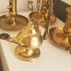 Many candlesticks and a small oil lamp.