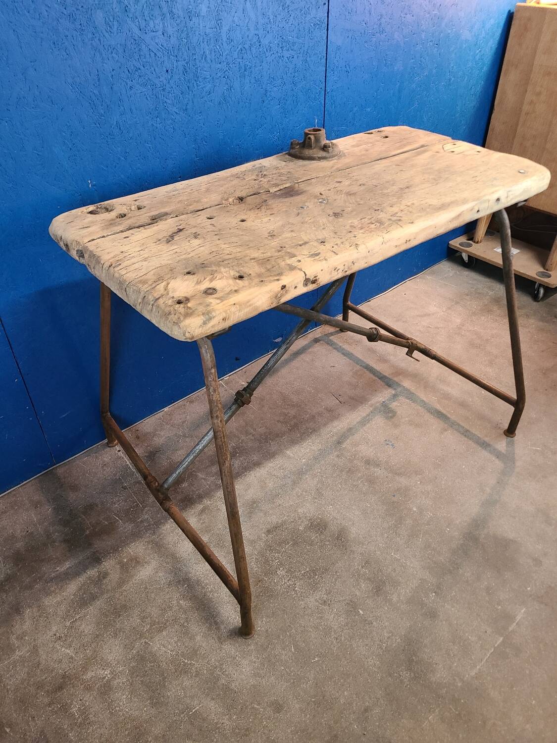 Vintage workbench circa 1930, folding metal leg.