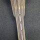 Set of 7 silver-plated dessert spoons with a bi-lobed filet pattern.