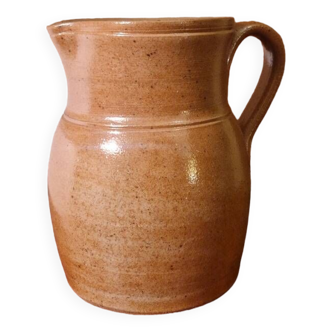 Old water pitcher in brown stoneware