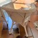 2 white wicker armchairs