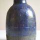 Ceramic bottle vase with a fish signature to be identified.
