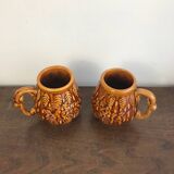 Set of 2 vintage caramel-colored slip mugs with flower pattern