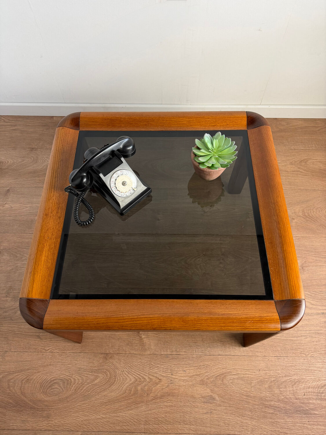 Square wooden coffee table with glass.