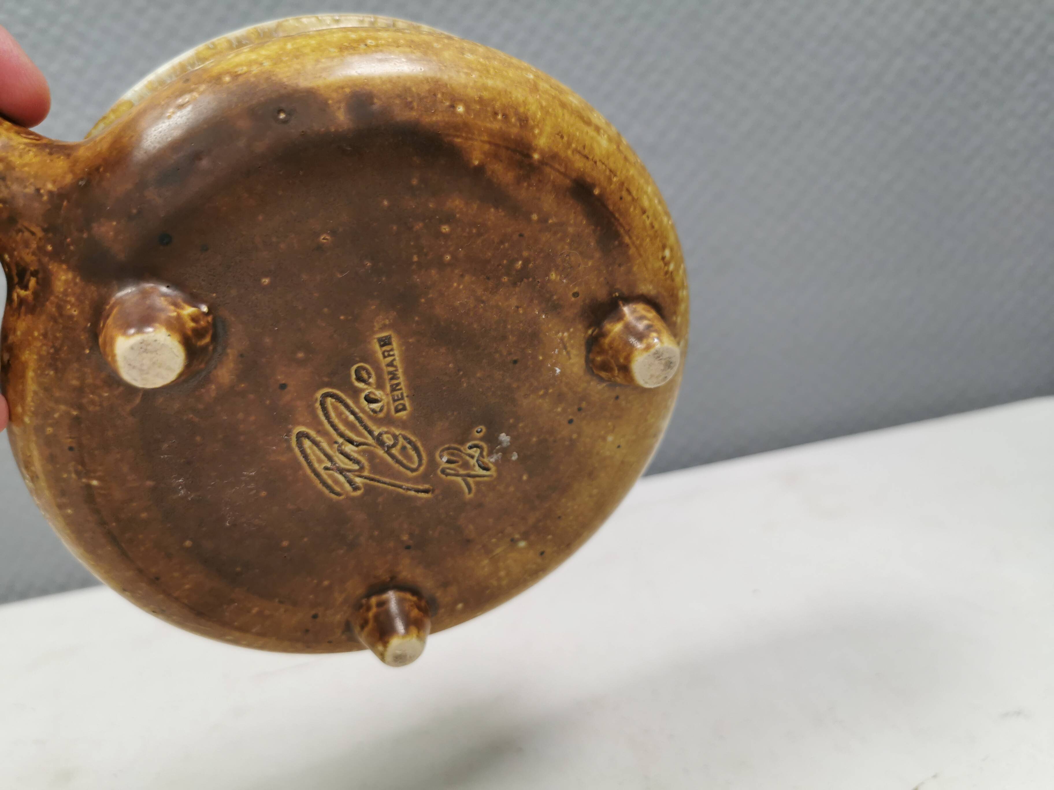 Small ceramic bowl with handle, in golden colours. Danish 1960-70s