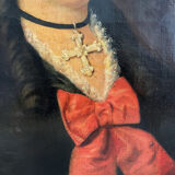 Old oil painting on canvas portrait of a woman with a red bow, late 19th century