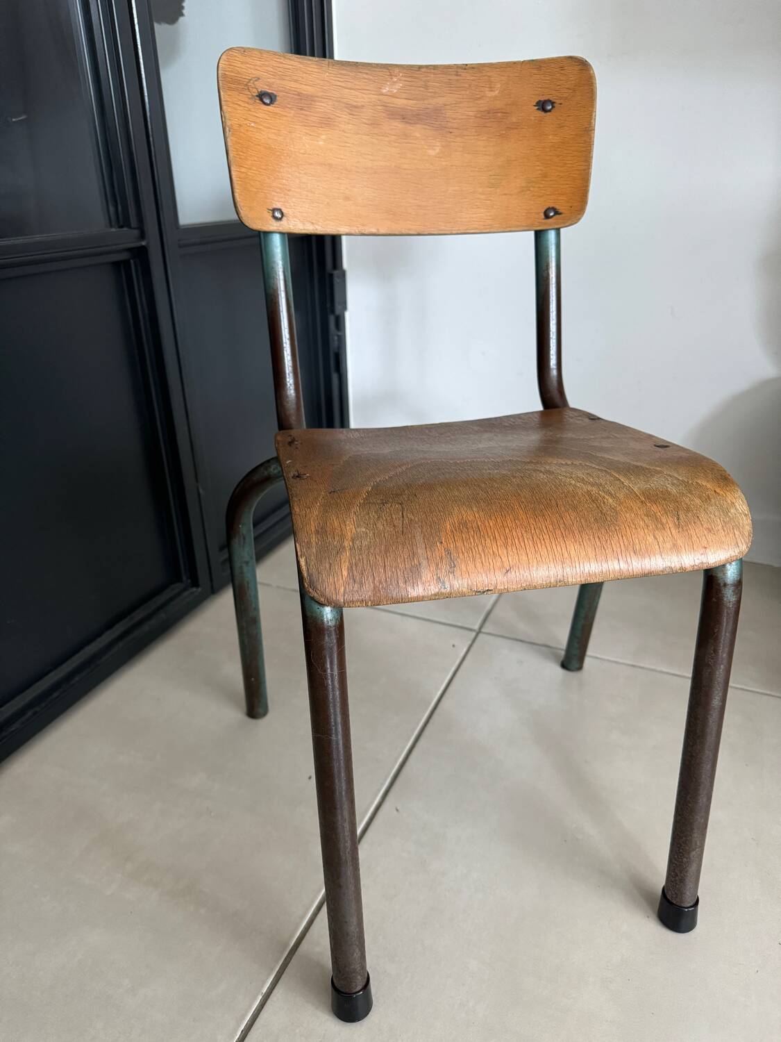 Old wooden and metal children's school chair
