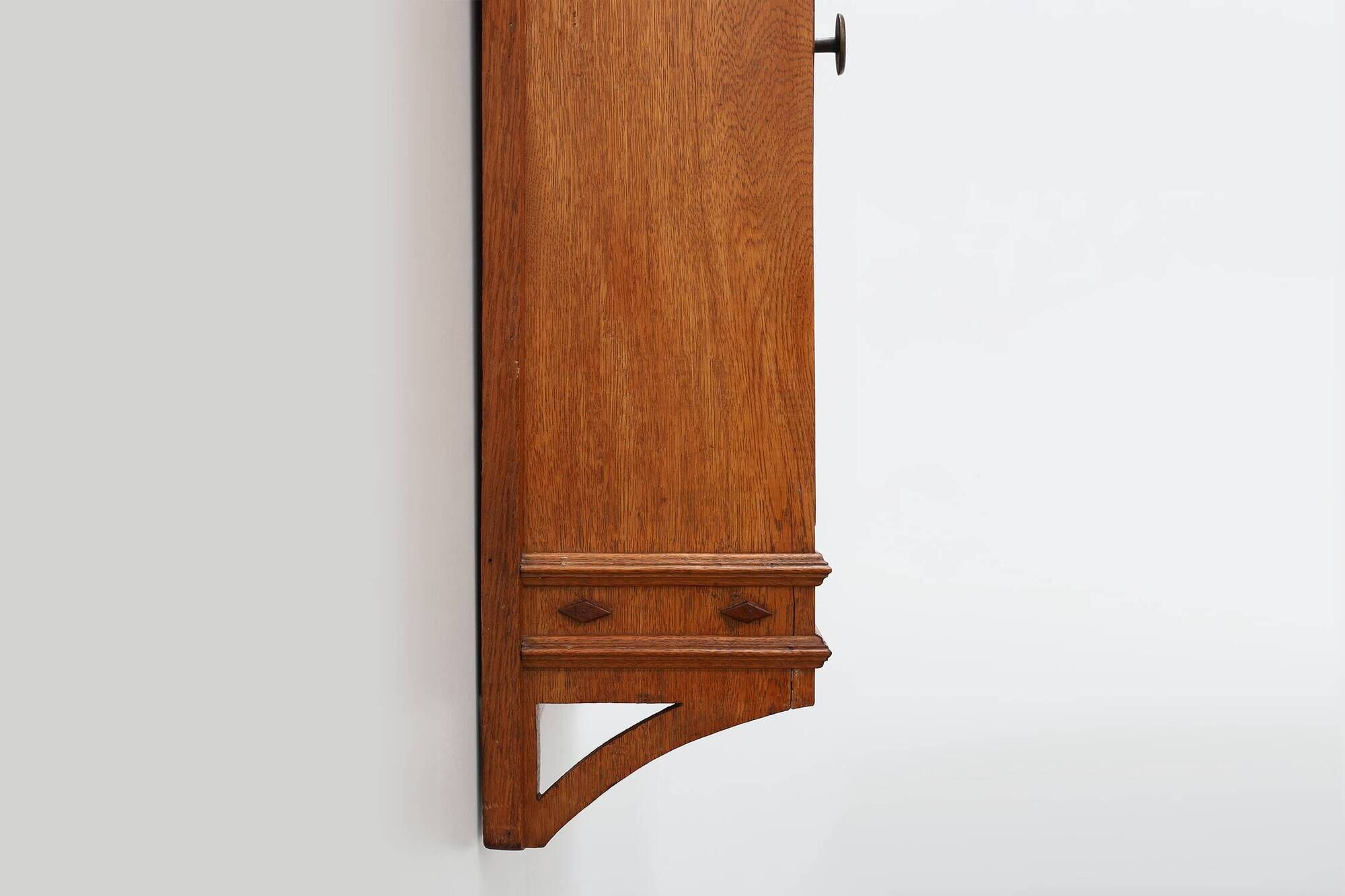 Art Deco oak wall cabinet with amber glazed door, Belgium ca. 1925