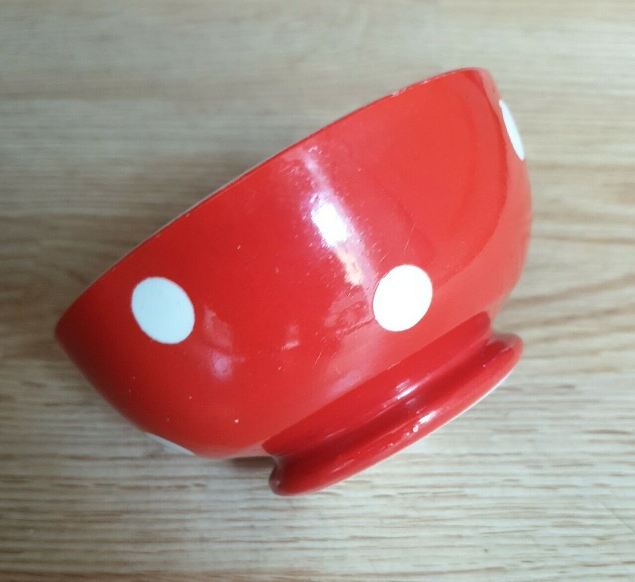 Red bowl with white polka dots signed Longchamp Porcelaine France