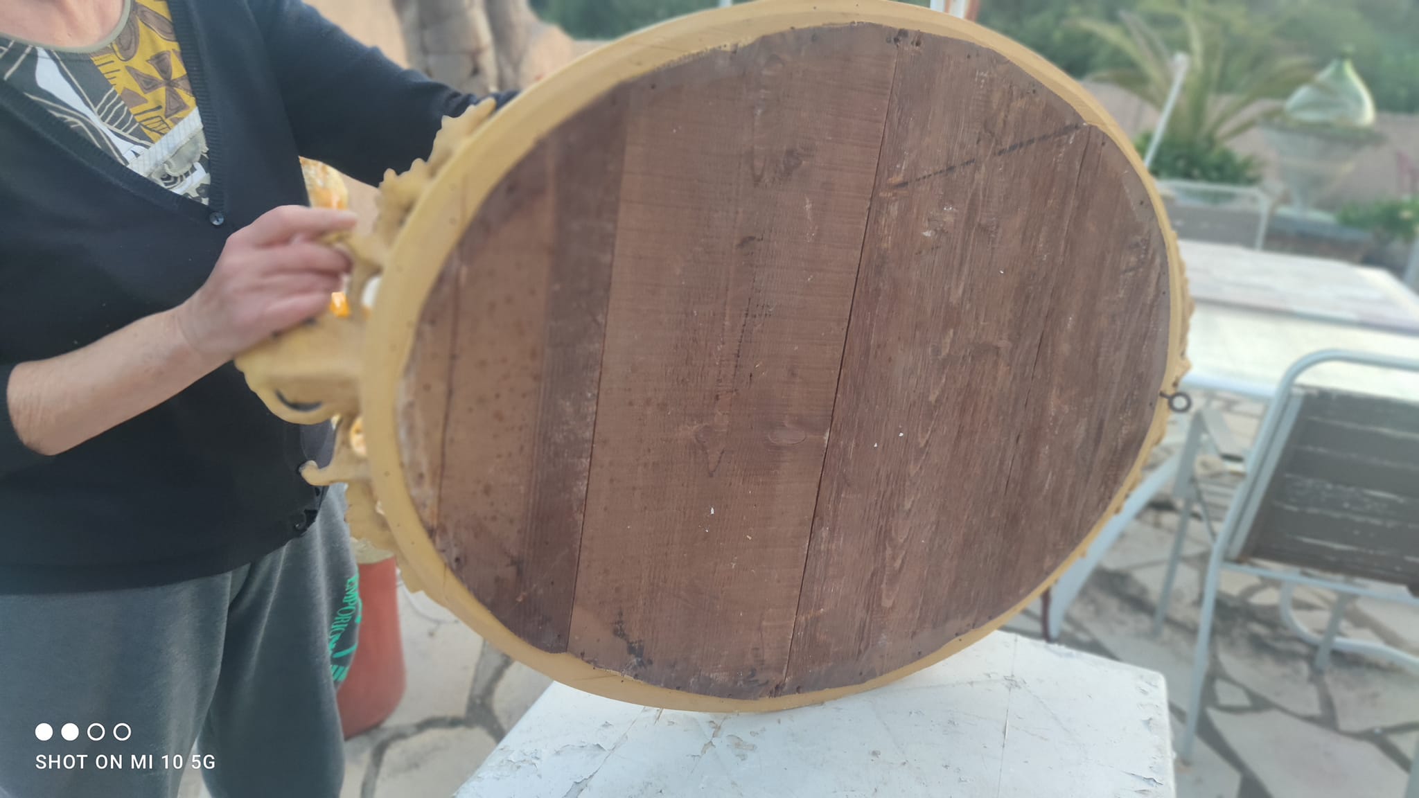 Ovoid mirror with double gilt pediments, circa 1830, 105x66 cm