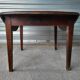 Antique round farmhouse table with drop-leaf doors in solid pegged wood