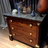 Empire chest of drawers with half columns in mahogany and gilded bronze