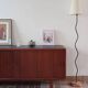Teak enfilade, sliding doors, black faux leather top, 1970s.
