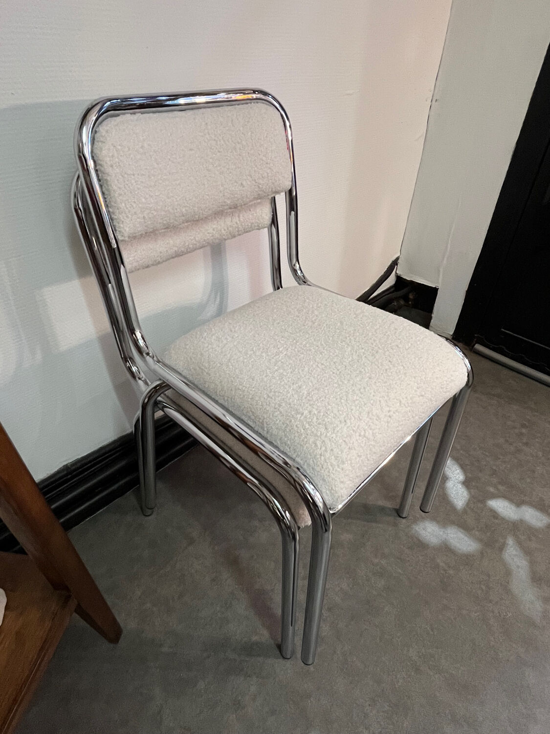 Pair of chrome chairs upholstered in boucle fabric.