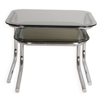 Pair of nesting tables in smoked glass and chrome legs.