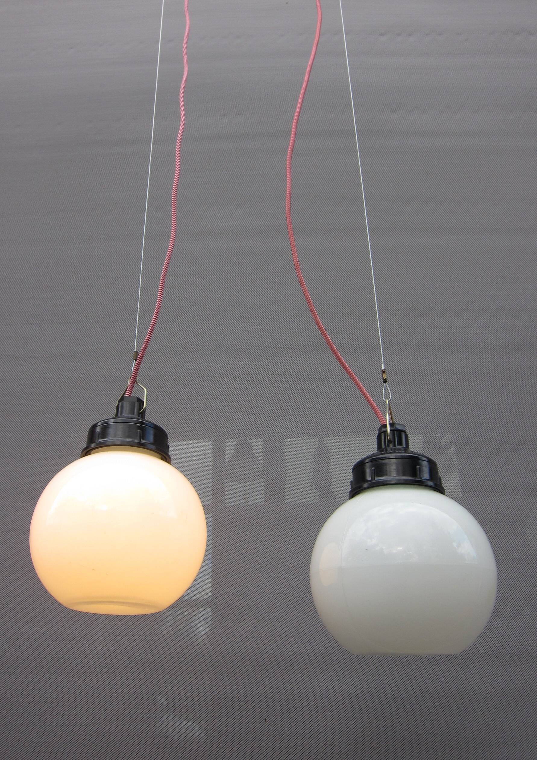 Trio of opal glass and bakelite globe pendant lights