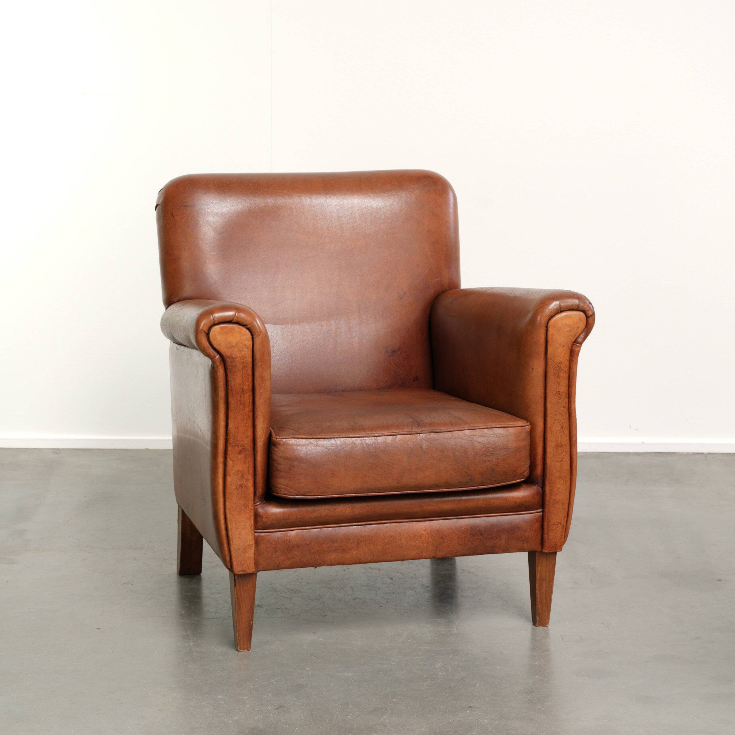 Sturdy vintage sheepskin armchair with a beautiful cognac colour