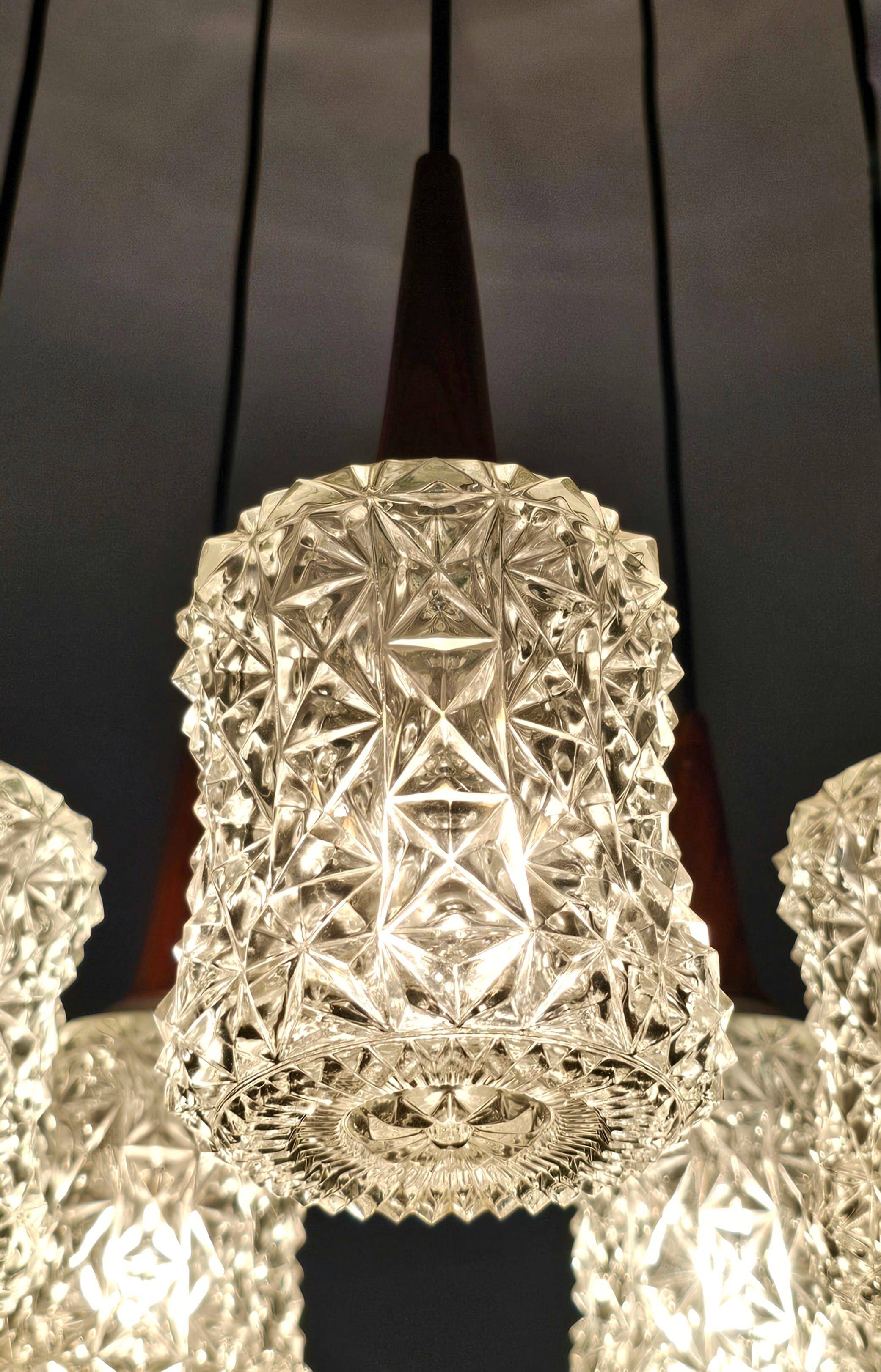 Mid Century Modern spider chandelier in teak, rosewood, and crystal.