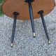 Vintage coffee table with glass top and tripod legs in blackened wood from the 1960s.
