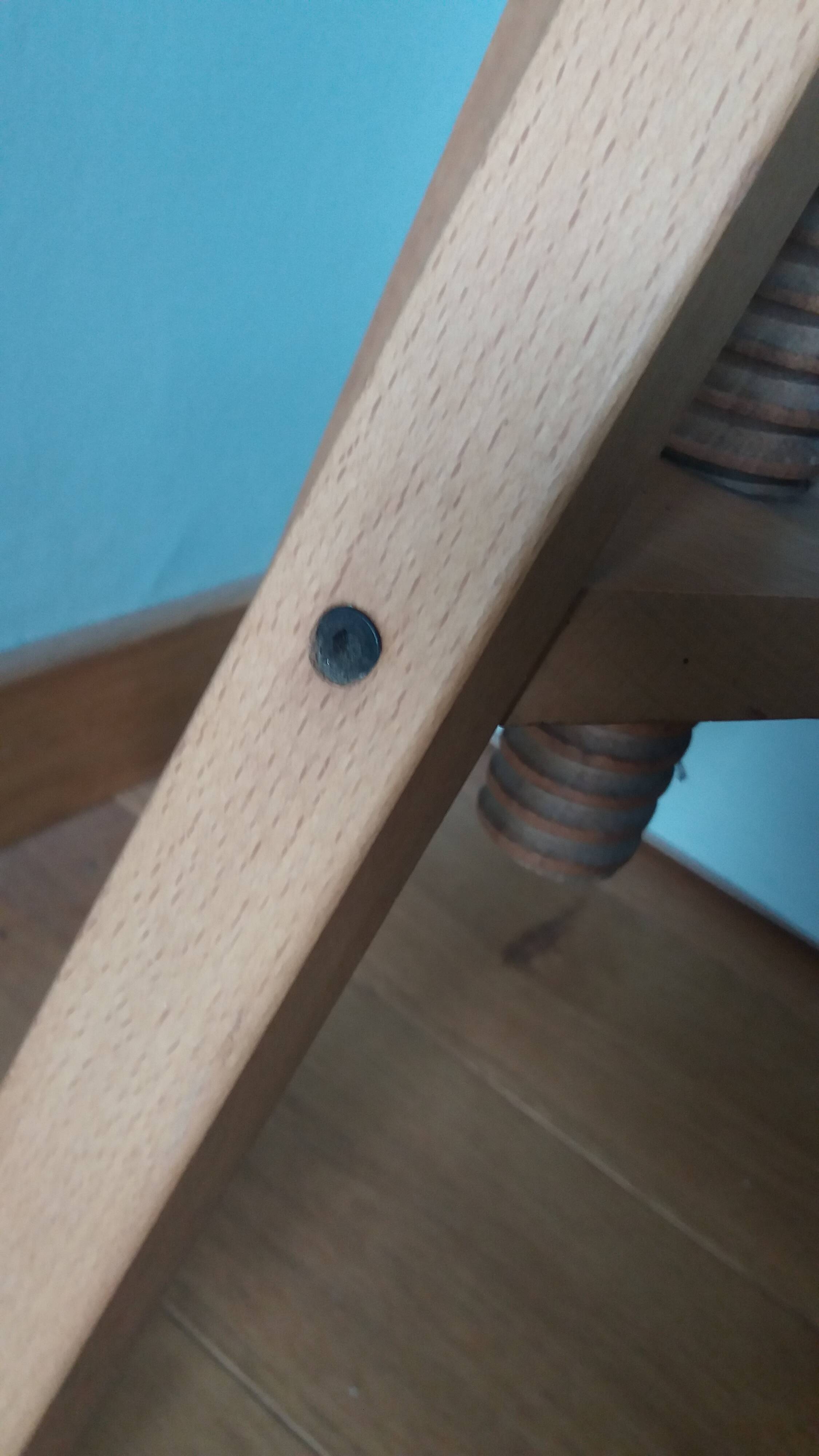 Tripod stool with a screw.