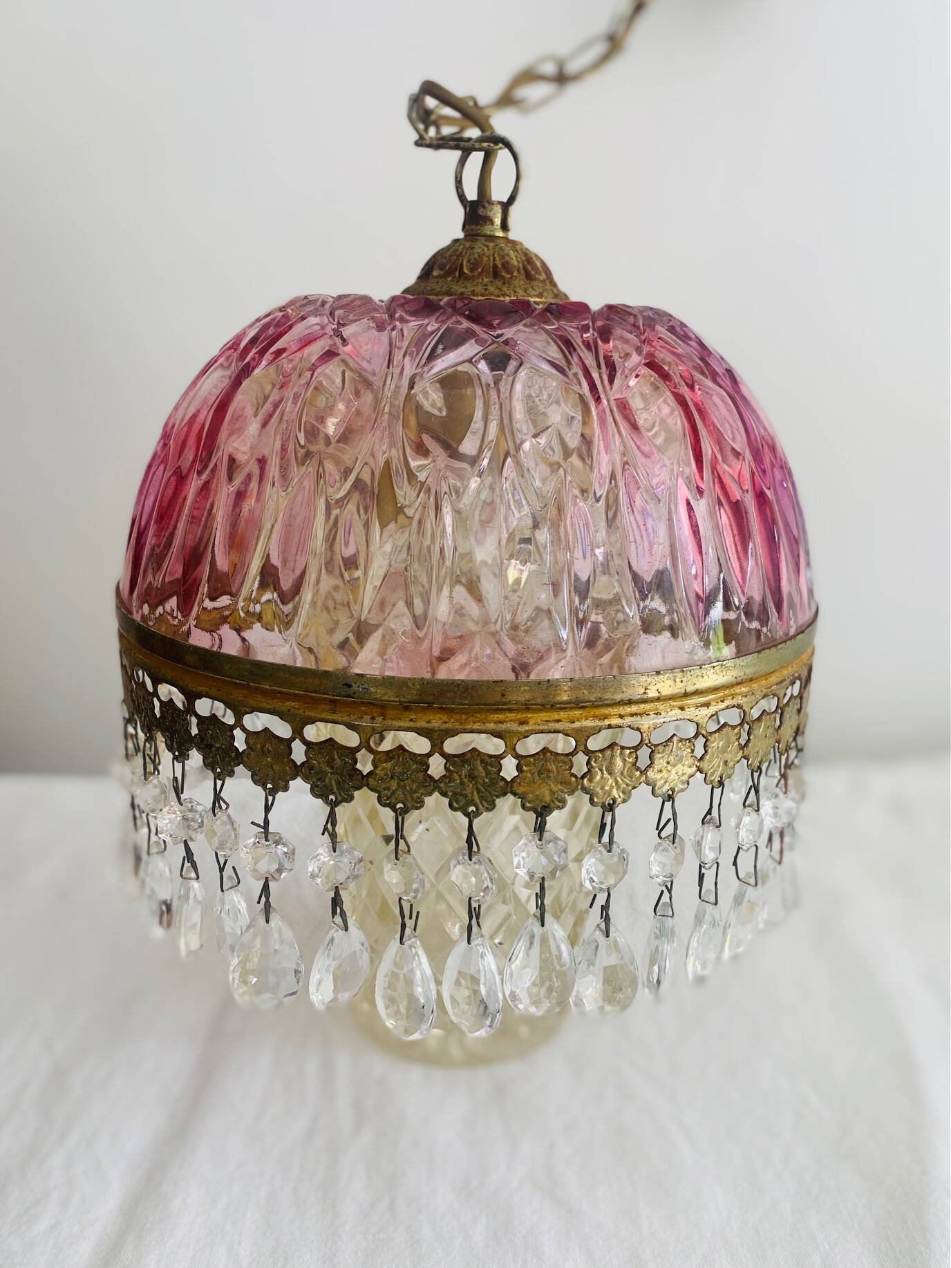 Antique pink glass pendant light with tassels.
