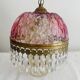 Antique pink glass pendant light with tassels.
