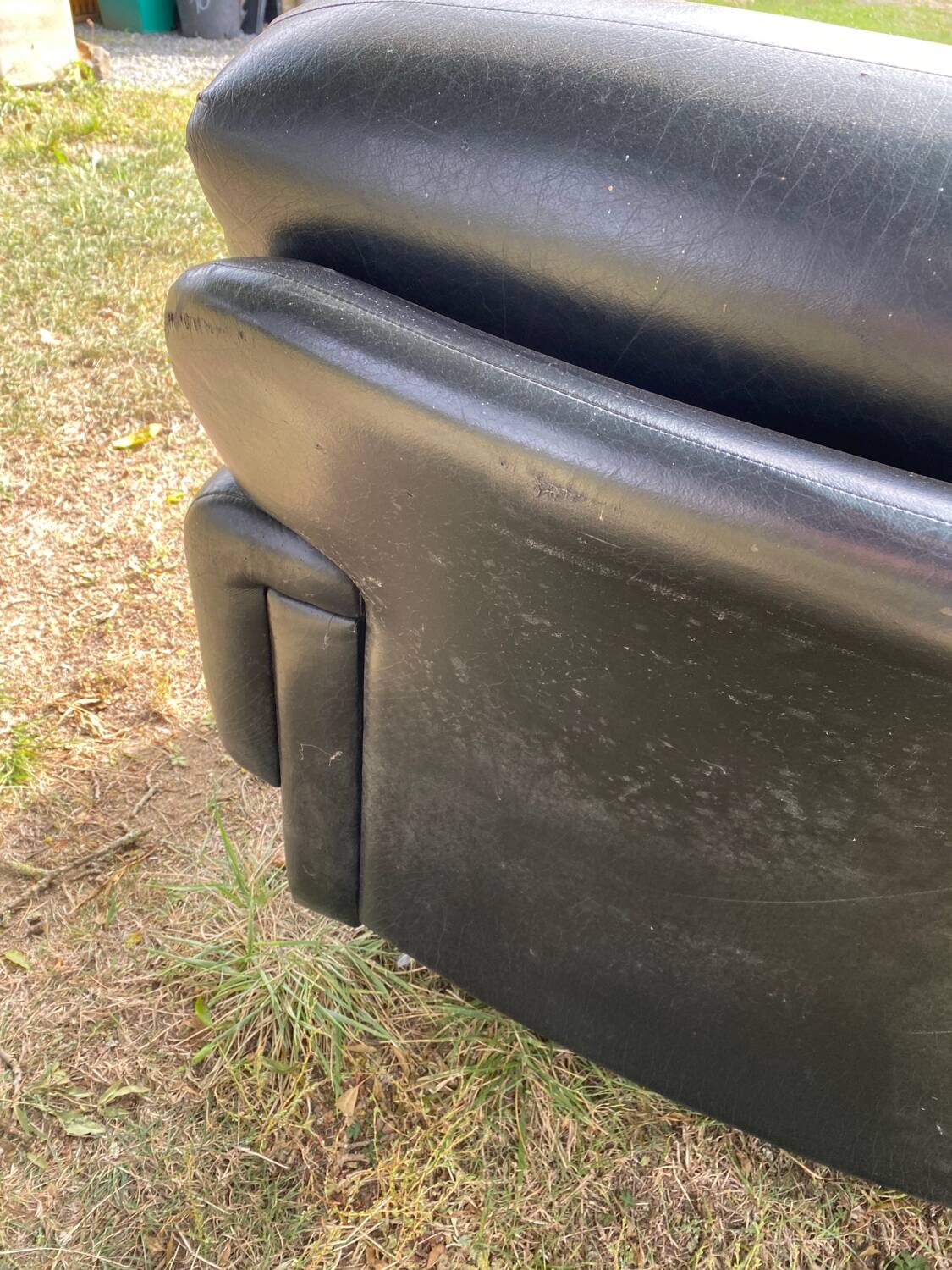 Pair of black imitation leather armchairs