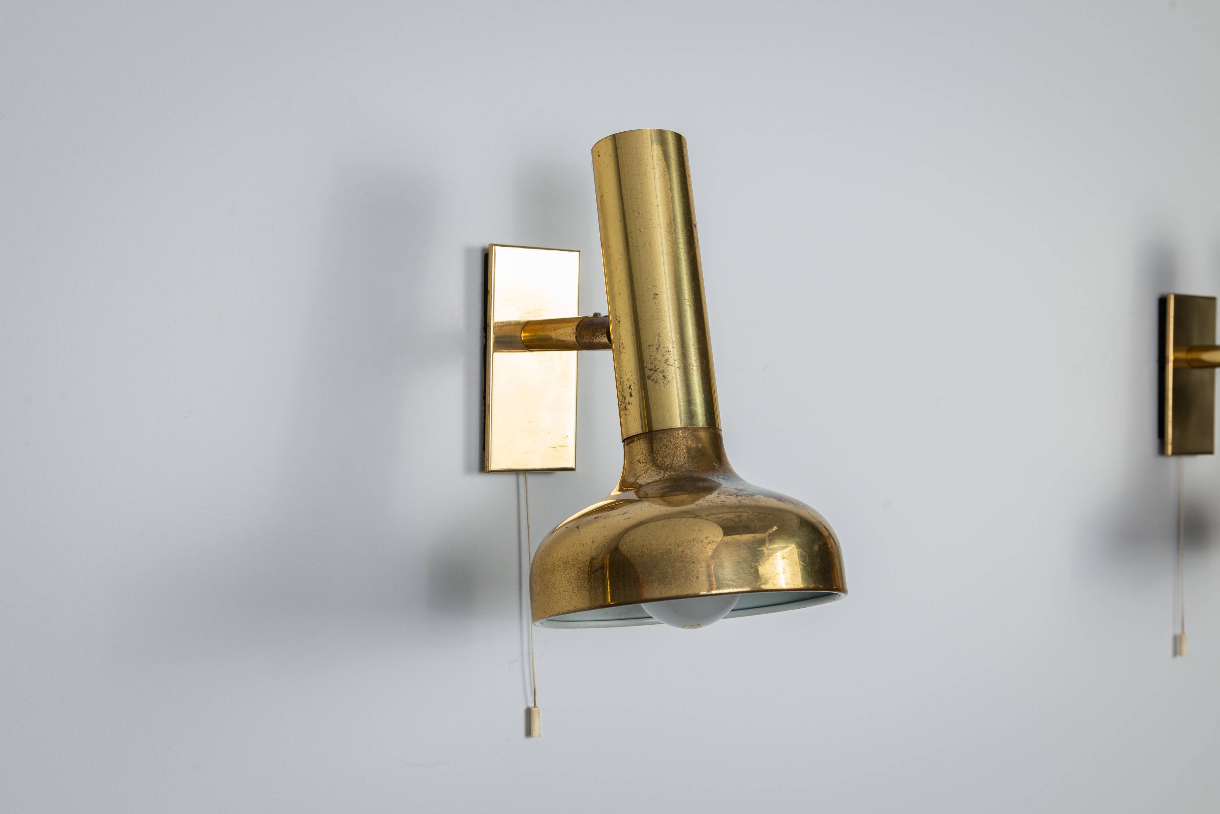 Set of three brass adjustable wall lamps