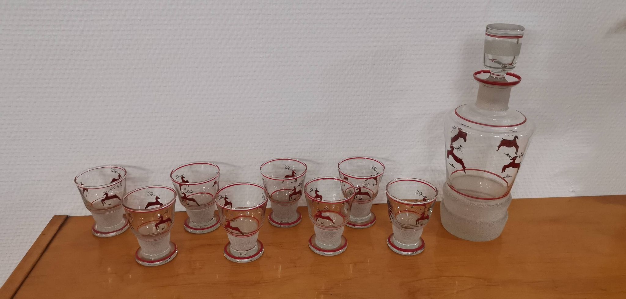Glasses and carafe decorated with red Christmas reindeer and white granita 60's
