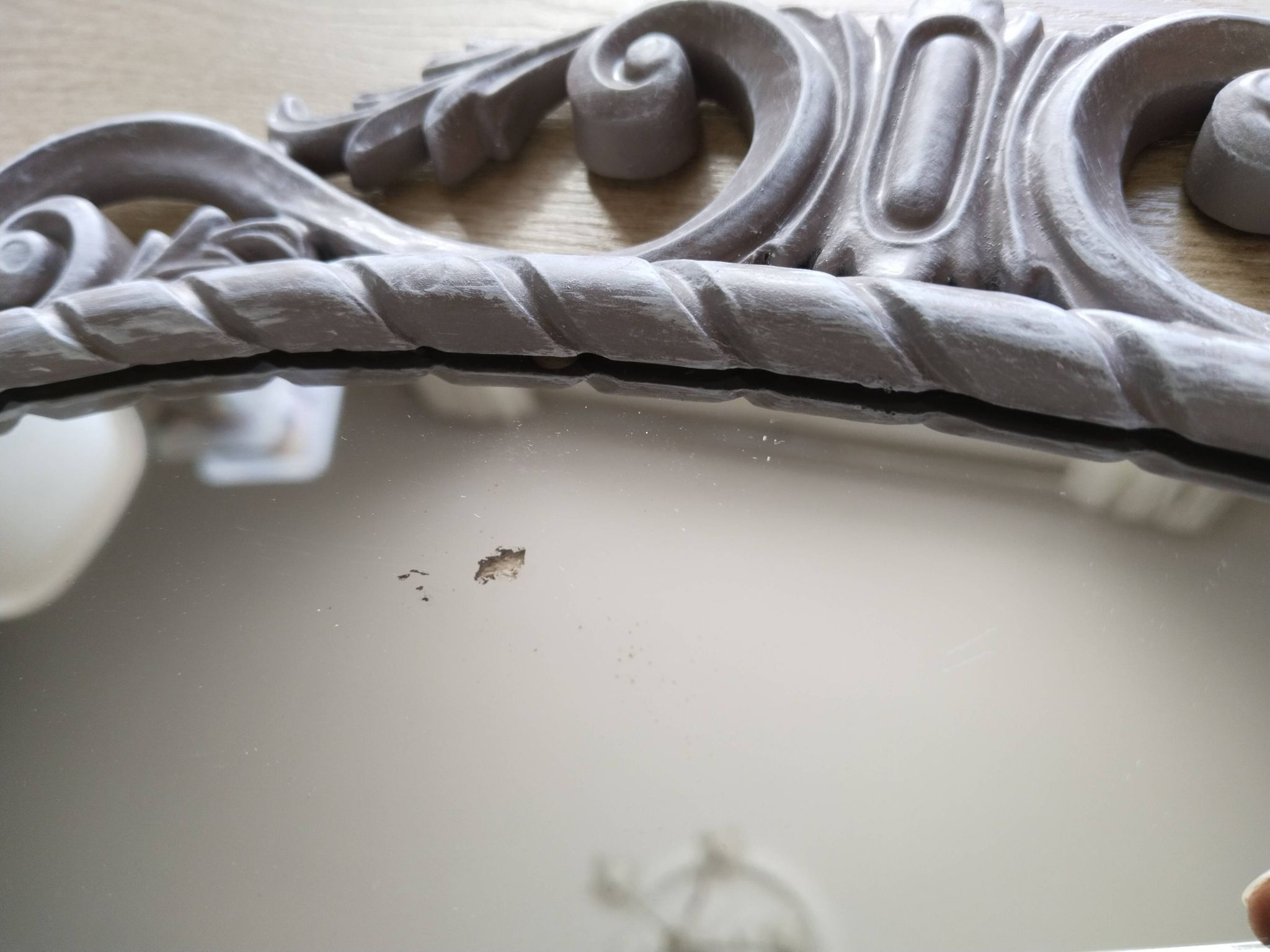 Louis XVI style patinated oval mirror