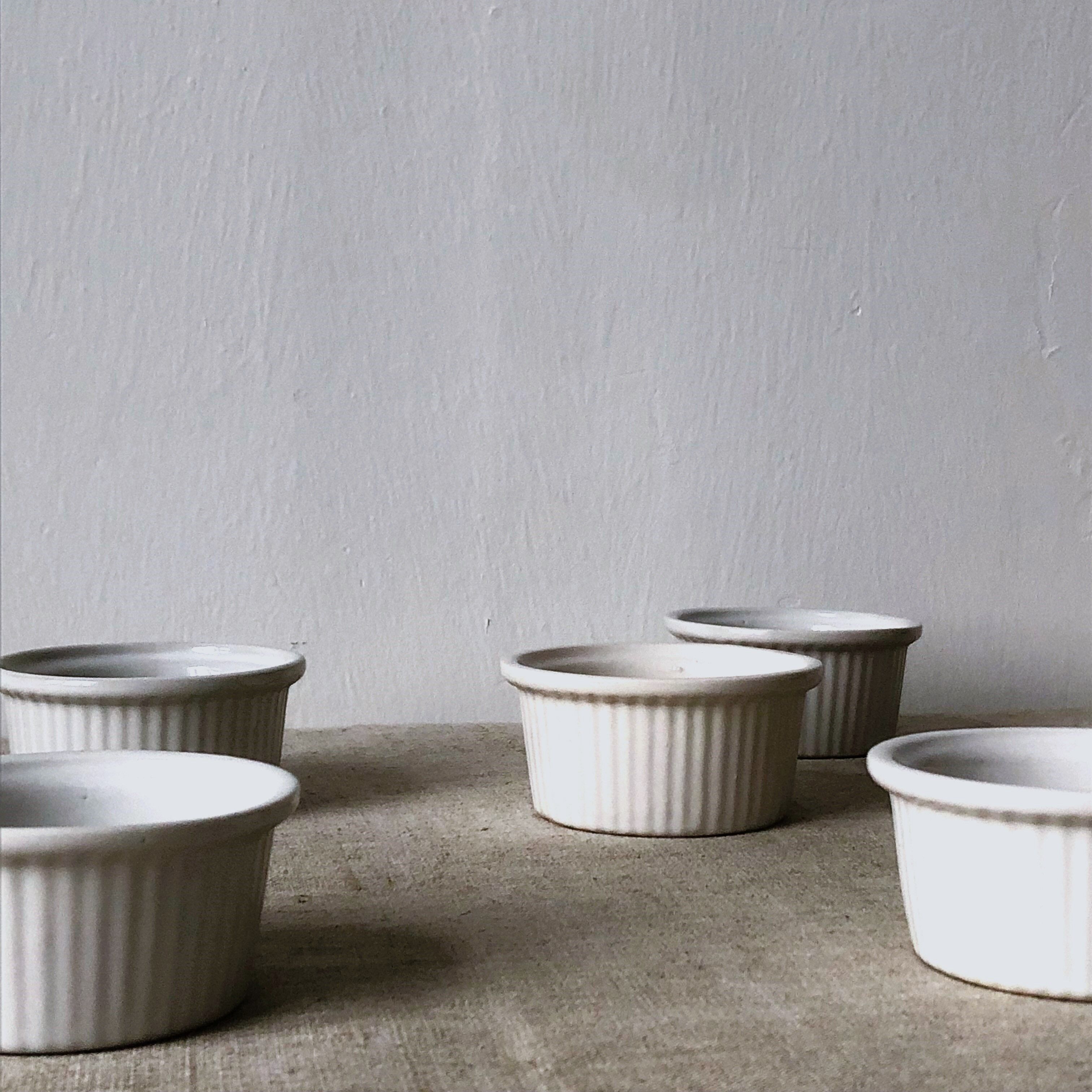 Pleated ramekins for white enamelled crème brûlée.