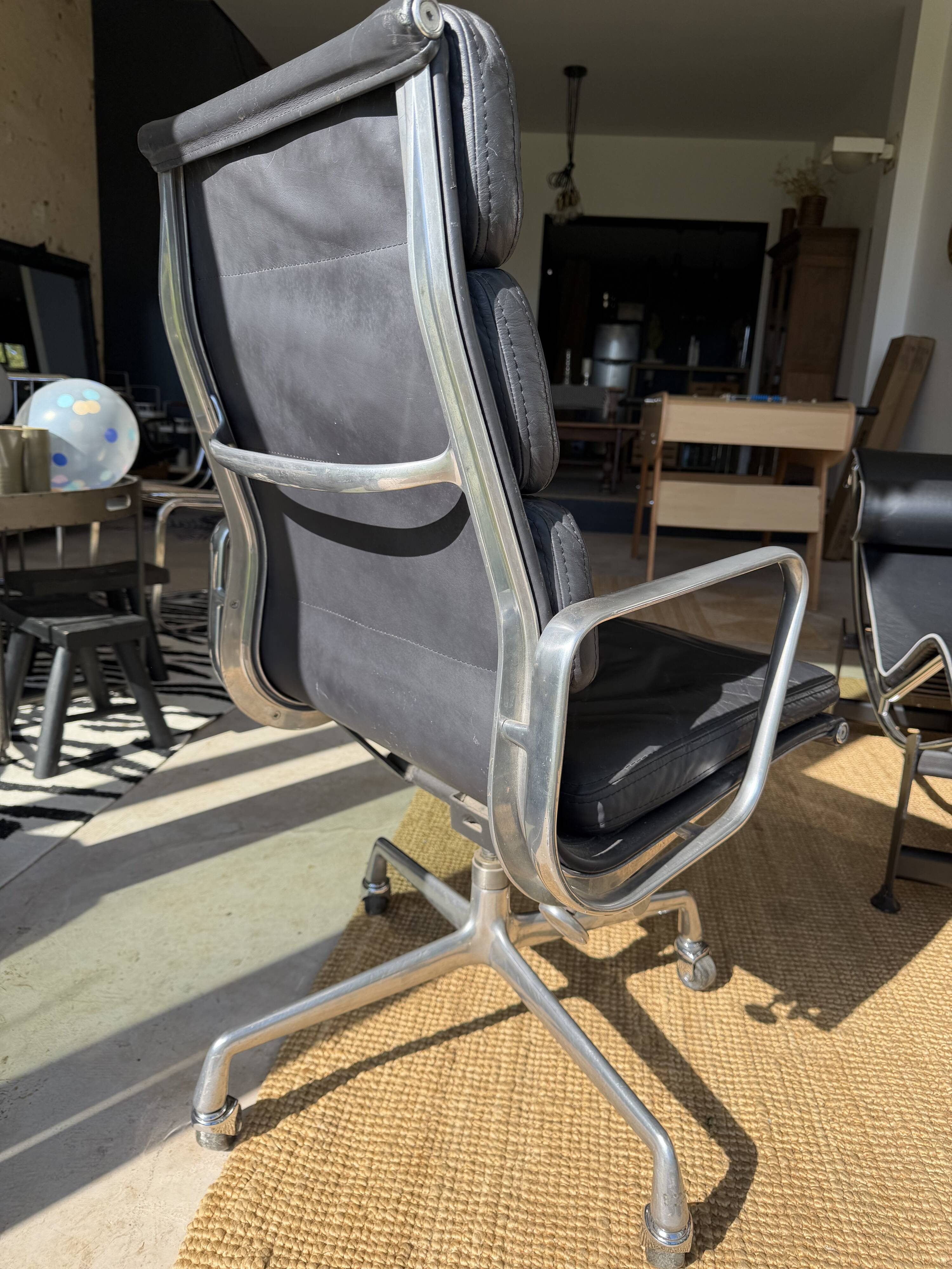 Eames soft pad chair in black leather, Herman Miller edition.