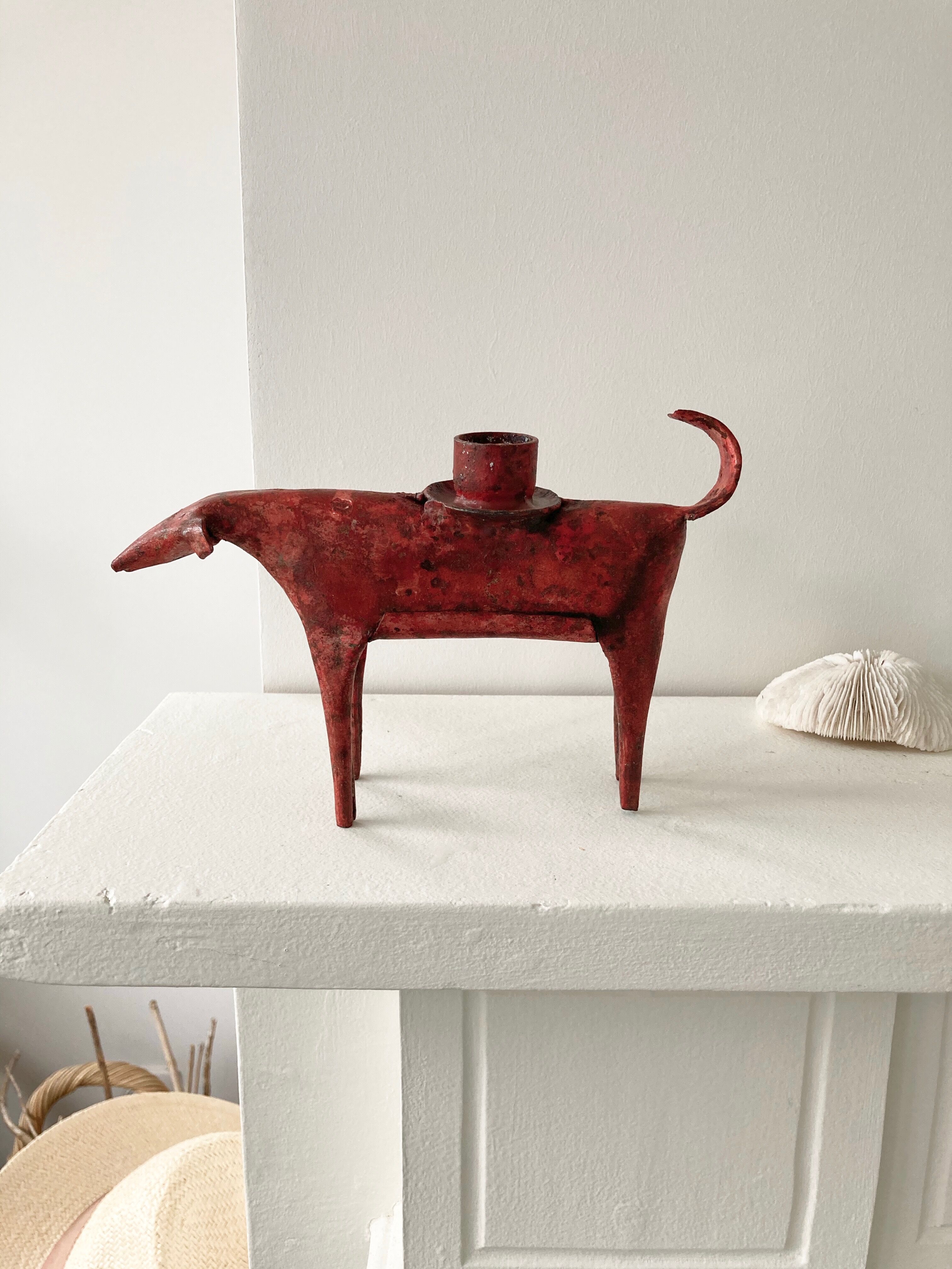 Zoomorphic candlestick made of red metal