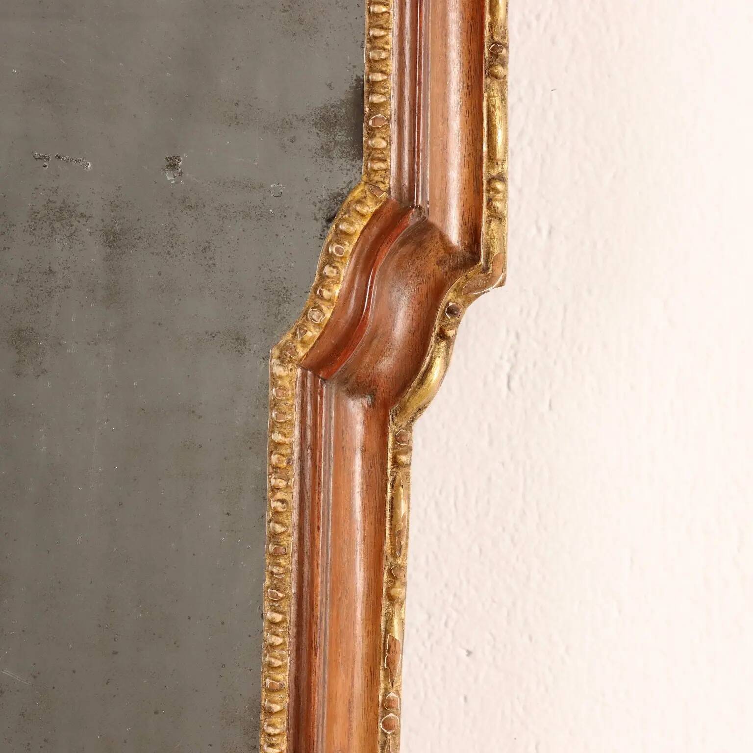 Neoclassical antique mirror in walnut, Italy, 18th century.