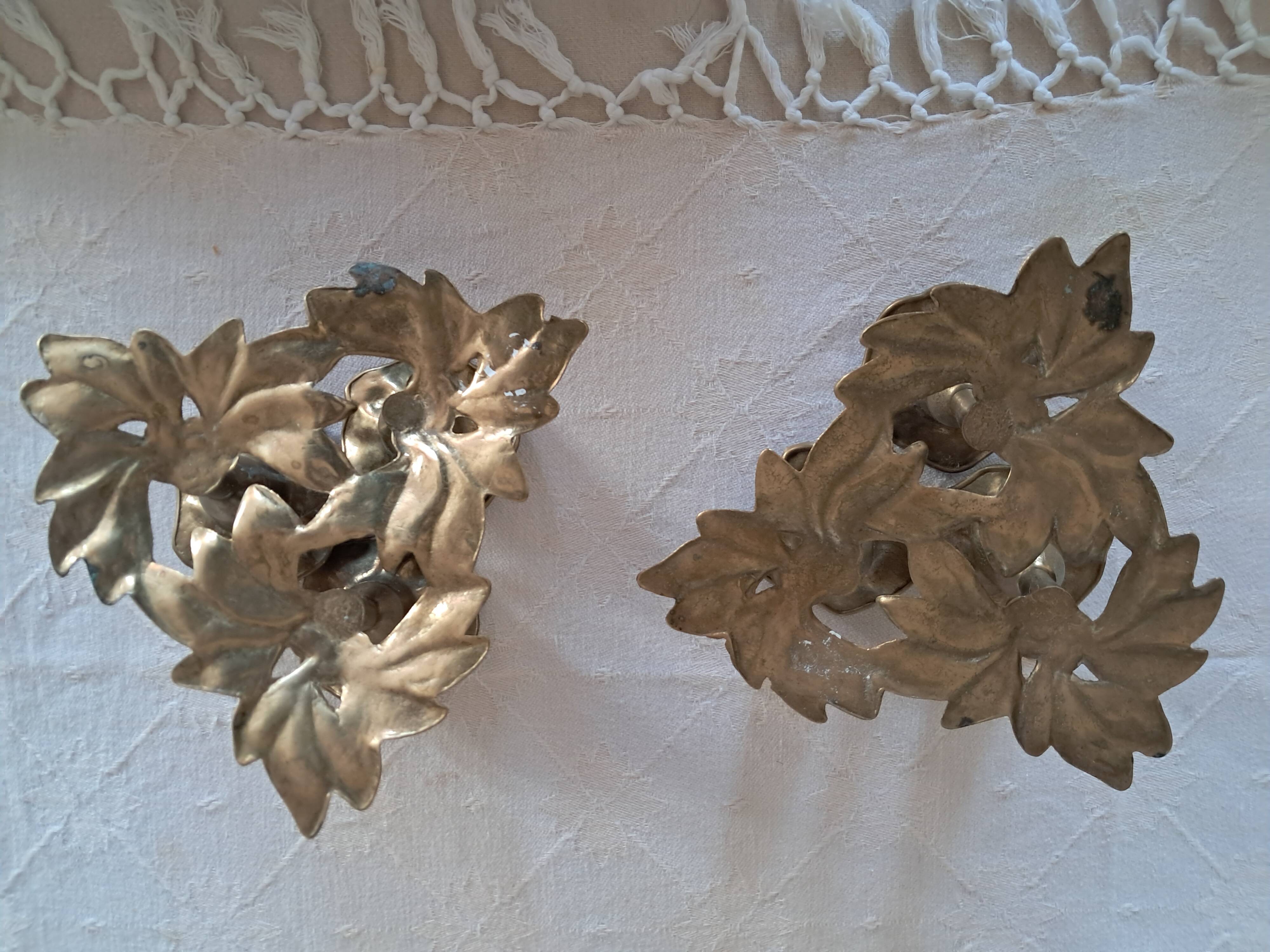 Pair of antique three-branch candlesticks with a floral design.