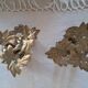 Pair of antique three-branch candlesticks with a floral design.