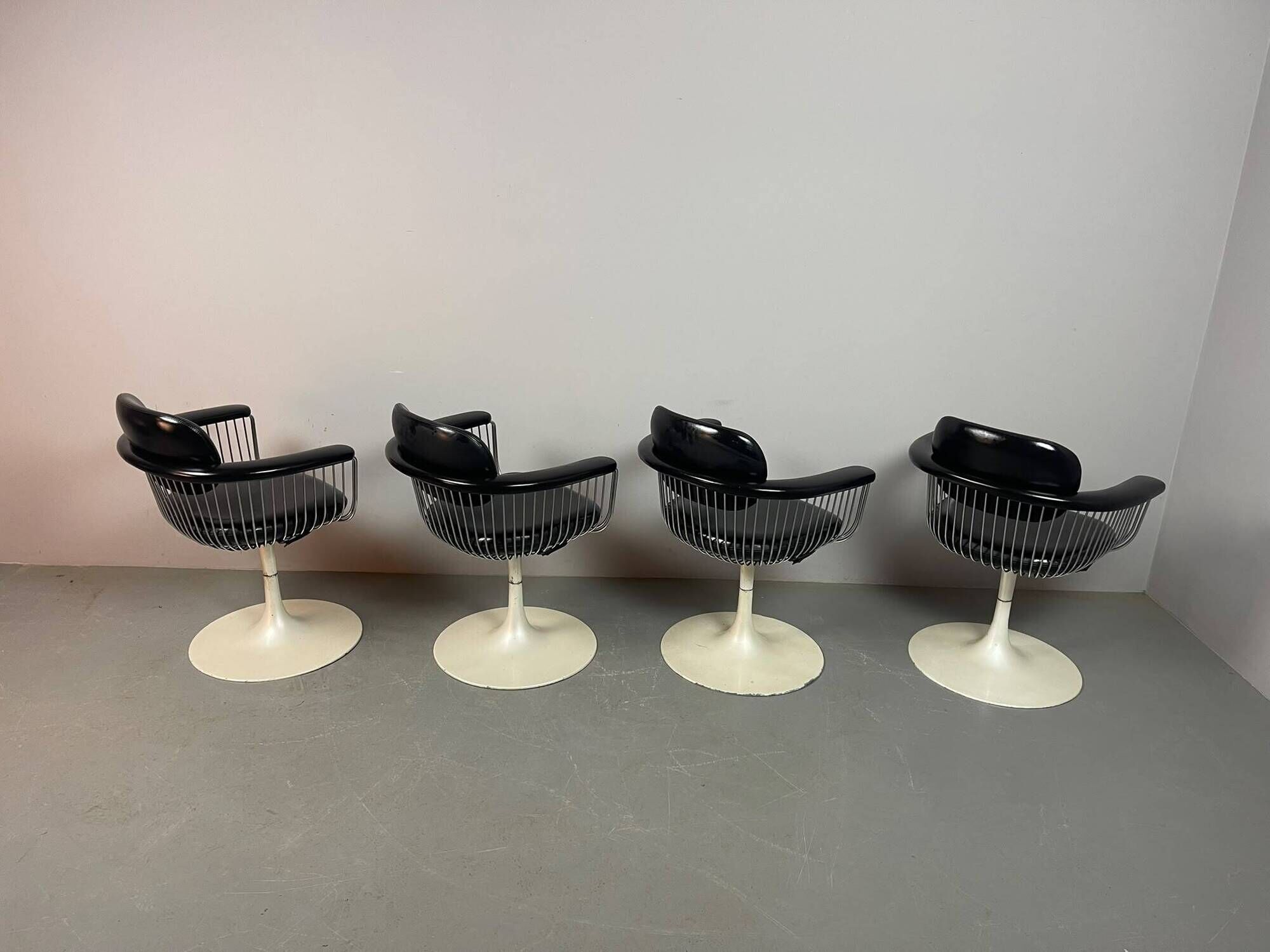 A striking set of four vintage swivel dining chairs