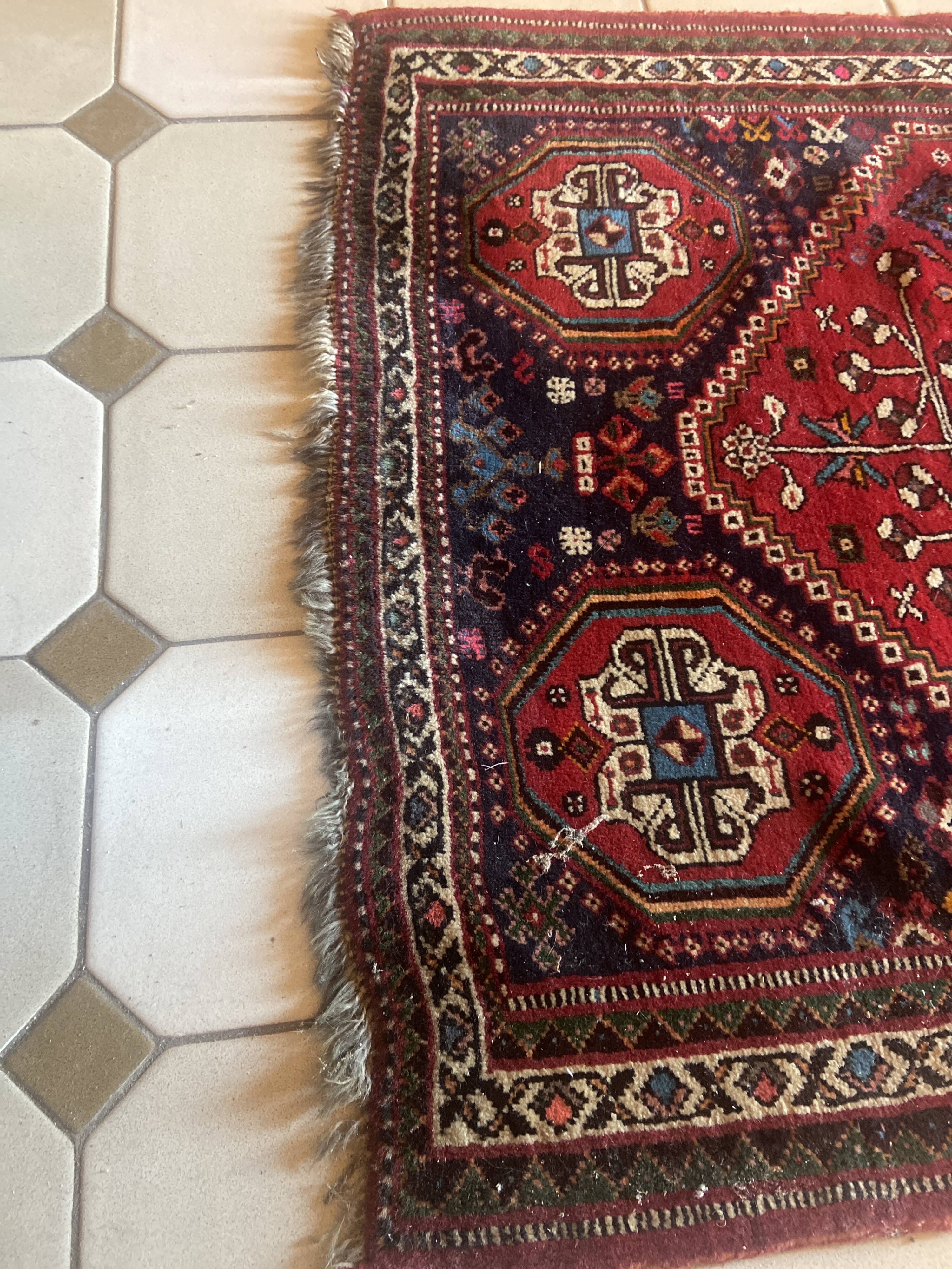 Large antique Oriental hallway carpet made of hand-knotted wool.