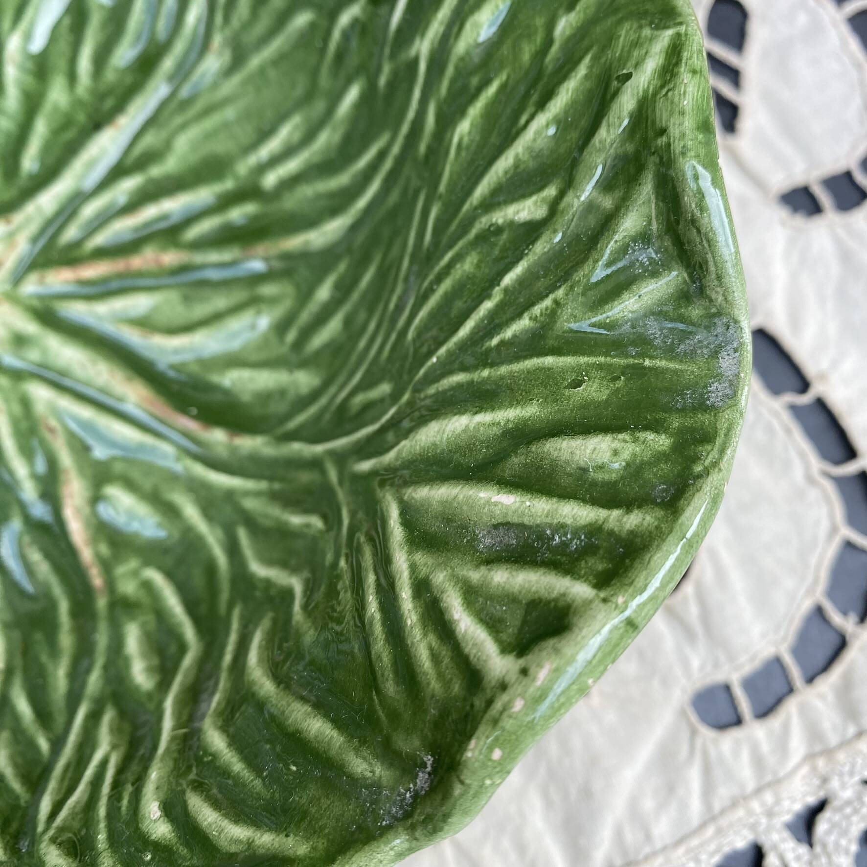 Large earthenware salad bowl in the shape of a cabbage leaf.