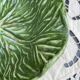 Large earthenware salad bowl in the shape of a cabbage leaf.