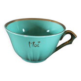 Green and gold cup from the Moi Salins collection.