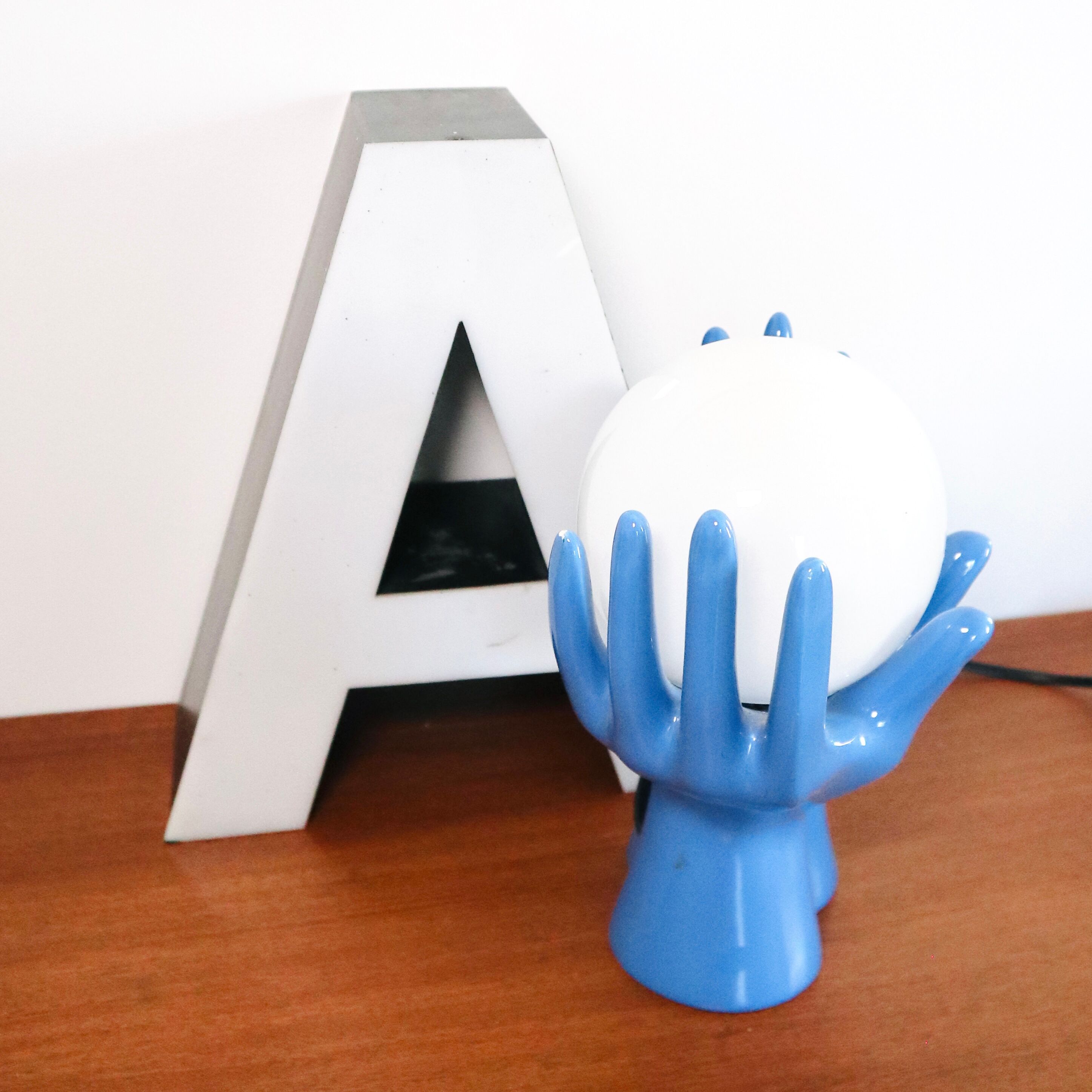 Ceramic lamp hands holding blue globe