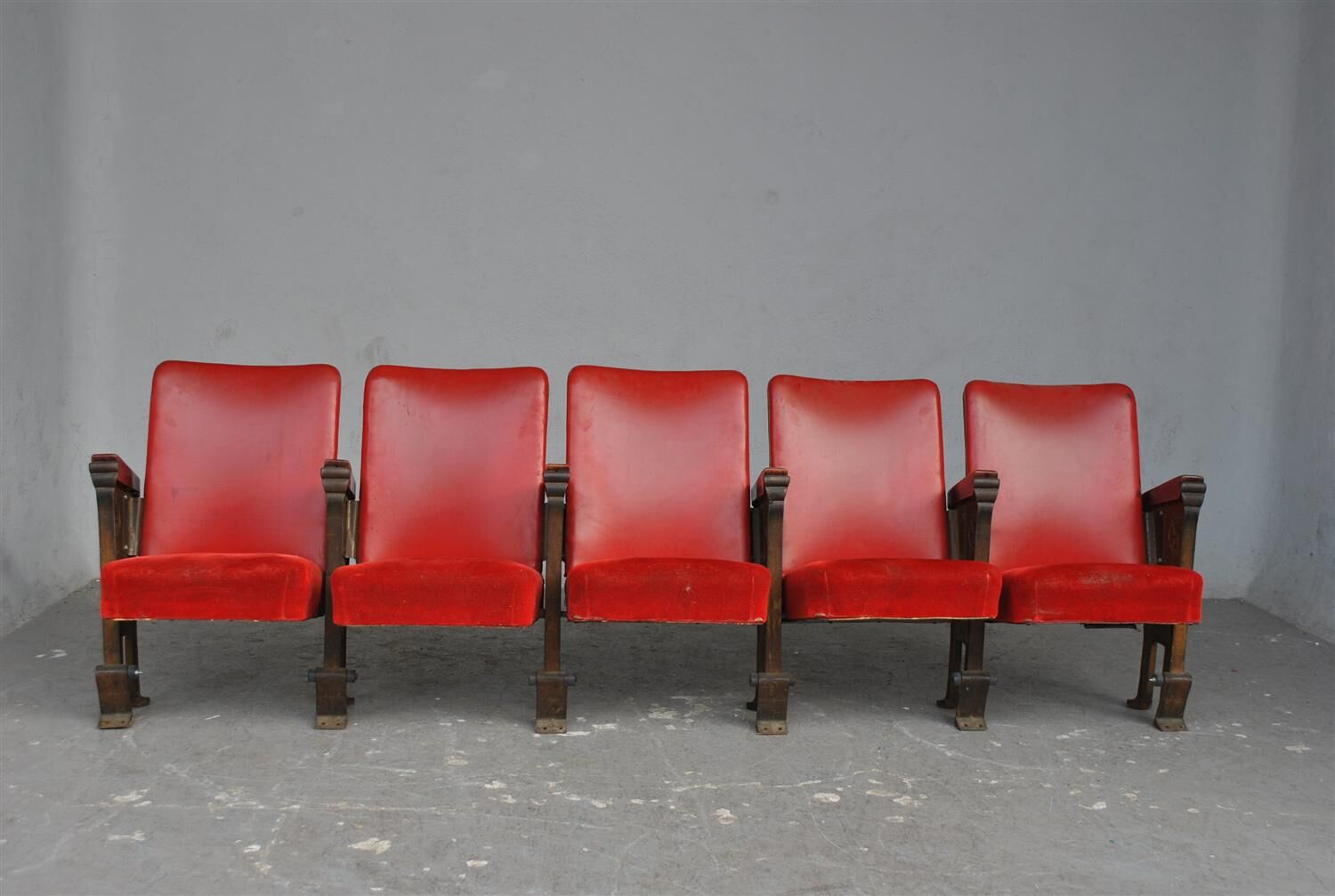 Series of 5 red skai and patinated cast Theater chairs