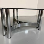 Round coffee table in smoked glass and chrome steel, 1970s design.