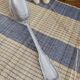 Large silver spoon with net decoration.