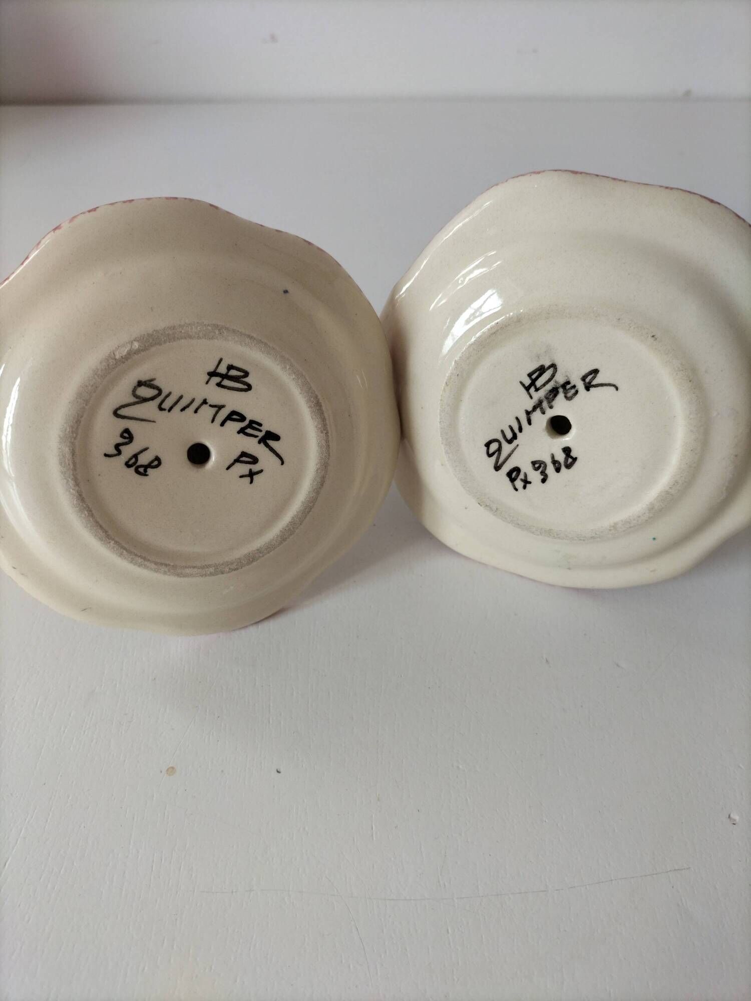 Pair of HB Quimper egg cups with integrated pedestal base, floral decoration