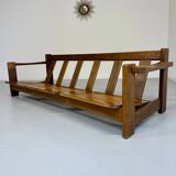 Old 3-seater sofa in solid wood, Maison Regain design, from the 70s.