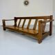 Old 3-seater sofa in solid wood, Maison Regain design, from the 70s.