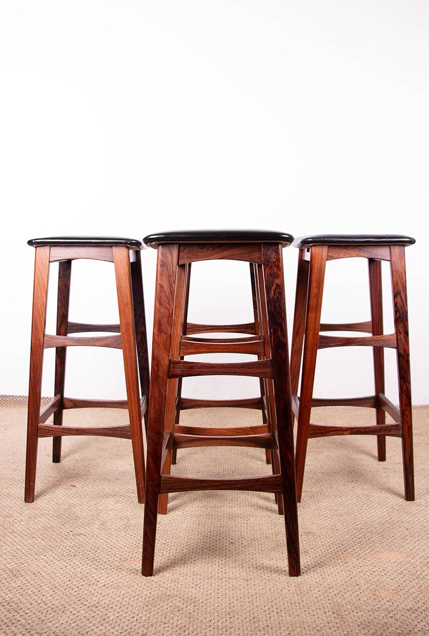 4 Danish high stools, rosewood and black leather, Knud Bent for Dyrlund.
