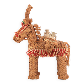 Folk donkey in woven wicker carrying jars